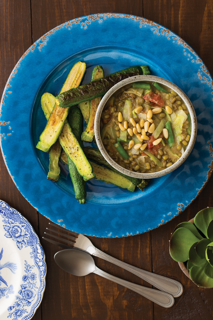 organic mung bean soup on a blue plate with fresh vegetables